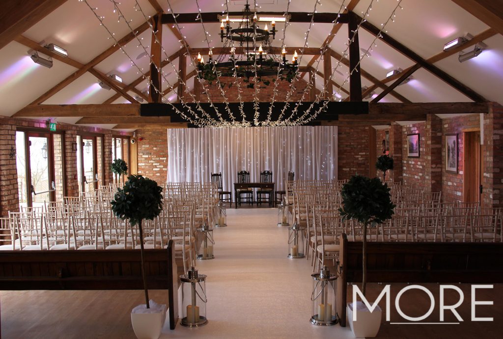Keythorpe Manor white carpet wedding aisle with fairy light canopy